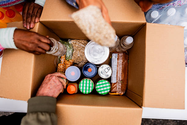 istock Volunteers packing food donation box 2249354724