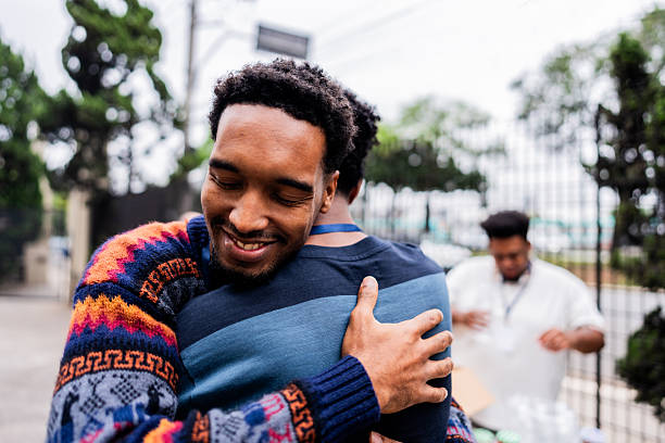 istock Friends sharing emotional embrace during community service project 2249354891