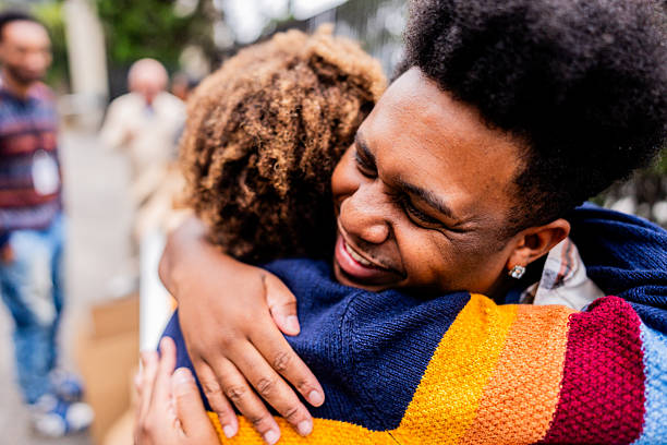 istock Young man embracing friend outdoors 2249354975