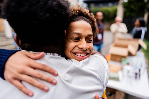 istock Friends sharing emotional embrace during community service project 2249354986