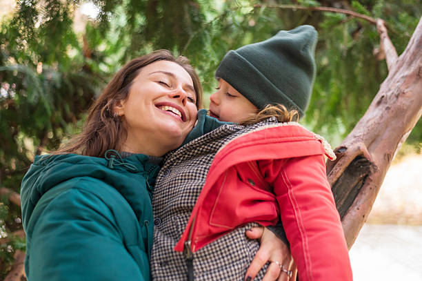 istock Young smiling mother hugging her son in the autumn park 2249355591