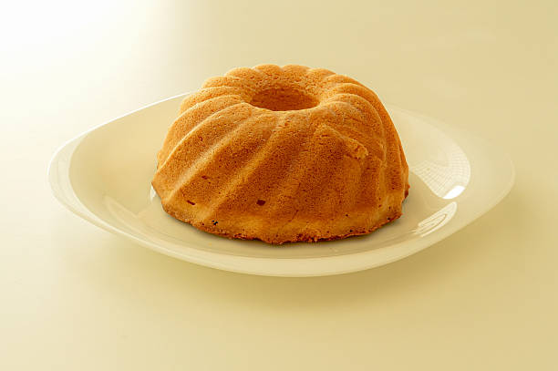 istock Cake on a white plate on a yellow background, close-up 2249358103