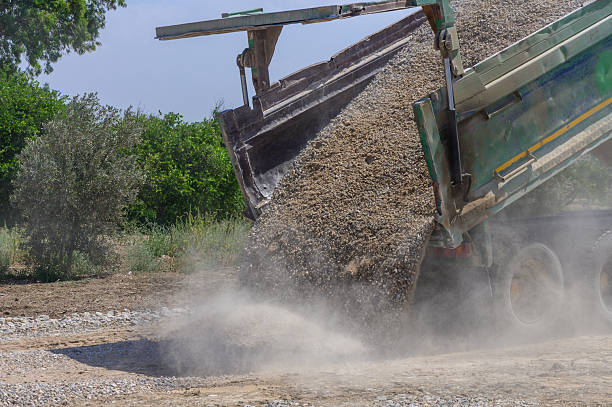 istock Dump Truck Unloading Gravel for New Road Project 2249358240