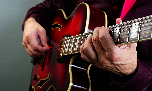 istock playing electric guitar. play the guitar closeup. 2249360445