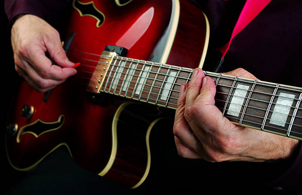 istock playing electric guitar. play the guitar closeup. 2249361055
