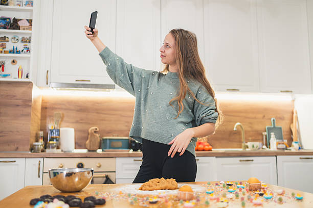 istock Woman Taking a Selfie with Gingerbread Dough on Kitchen Table 2249361264
