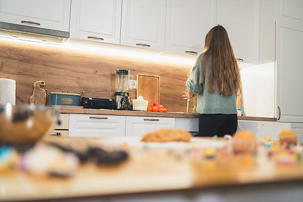 istock Woman Washing Hands While Gingerbread Dough Rests on Kitchen Table 2249361344
