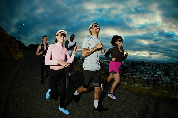 istock Young adults jogging city park at sunrise 2249362363