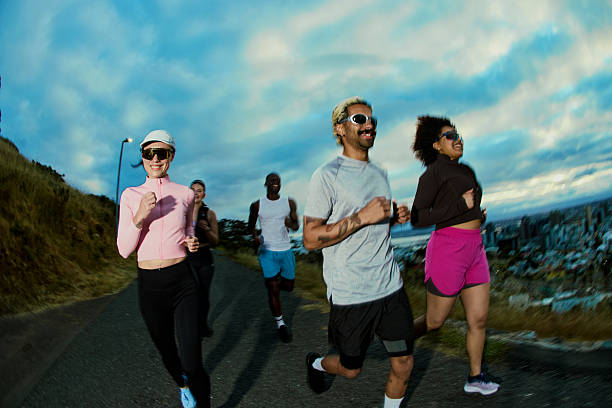 istock Young adults jogging city park at sunrise 2249362369