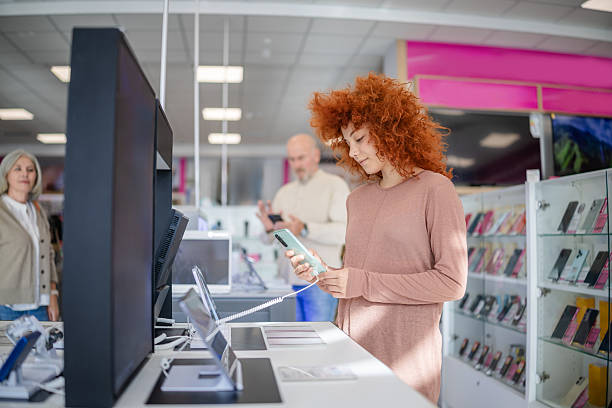 istock People shopping for technology in an electronics store, evaluating devices and options 2249362564