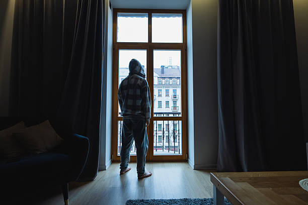 istock Man stands in front of window. Silhouette 2249363975
