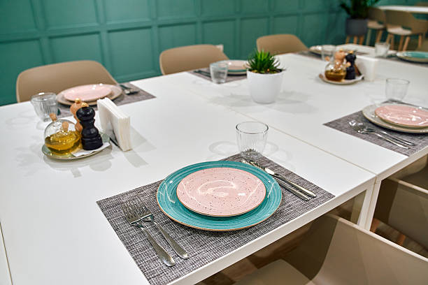 istock Elegant Dining Table Setup Featuring Pastel Plates and Contemporary Decor in a Modern Dining Space 2249364895