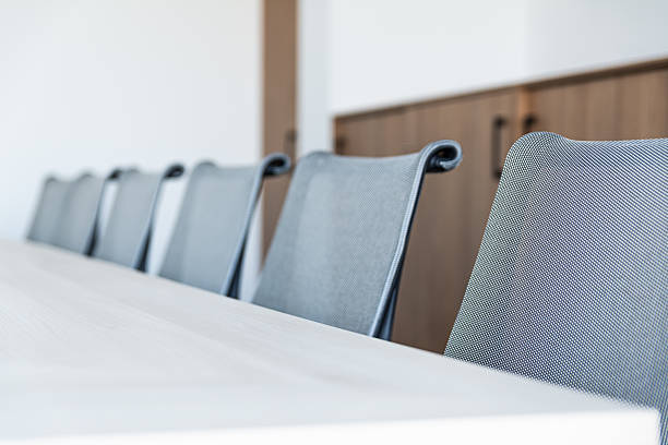 istock Modern Conference Room Chairs Arranged Along White Table In Bright Office Interior 2249366314