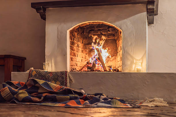 A cozy living room showcasing a stone fireplace, elegant dining area, and modern decor. the warm ambiance is enhanced by brown accents and comfortable seating.