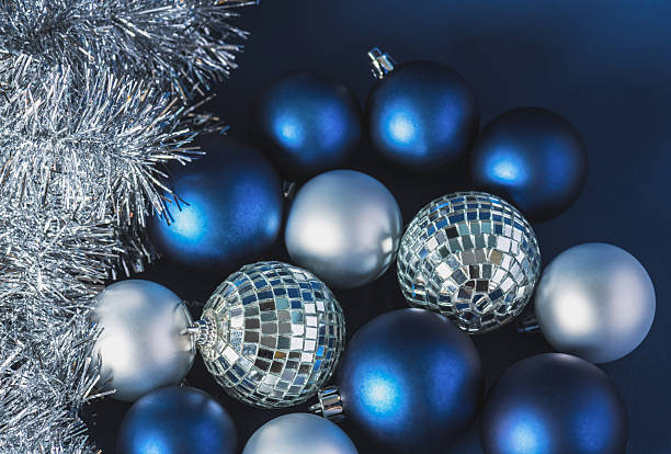 istock Christmas background, blue and silver balls, silver tinsel on a dark blue background. Creative composition with copy space, top view. New year, christmas, holiday, decoration. 2249368532