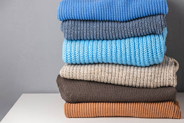 istock Stack of knitted wool sweaters in different colors. Warmth and comfort. Winter clothes. 2249368585