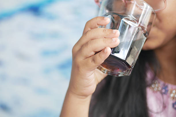 istock Young child enjoying a cold drink during a bright day 2249369316