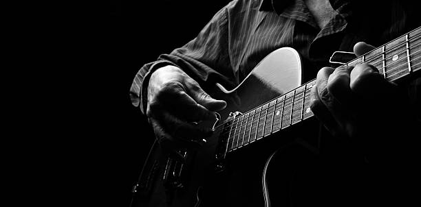 Playing an Acoustic Guitar. Black and white. Copy space