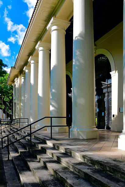 Honolulu, Oahu, Hawaii, USA: the Hawaii State Library, a historic Carnegie library, was designed in classical style by Henry D. Whitfield and completed in 1913, featuring a twenty-foot-high Tuscan-columned entrance lanai, bronze doorways and windows, a two-story skylit lobby, and cast-iron stacks, it serves as the flagship of the U.S.'s only statewide public library system with 51 branches across six islands - South King Street, Hawaii Capital Historic District