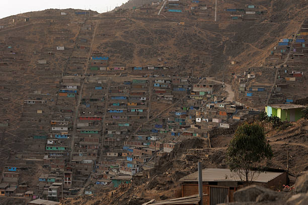istock Densely packed colorful houses stacked on a steep arid hill featuring long concrete stairs, illustrating urban overcrowding, poverty, and informal architecture in Lima, Peru 2249371302