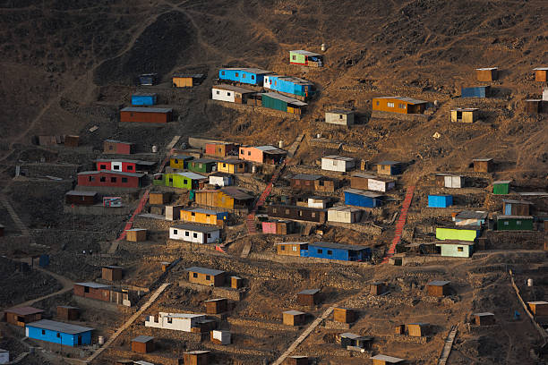 istock Densely packed colorful houses stacked on a steep arid hill featuring long concrete stairs, illustrating urban overcrowding, poverty, and informal architecture in Lima, Peru 2249371345