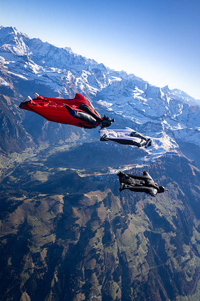 istock Wingsuit fliers fly in formation over snowcapped mountains 2249372978