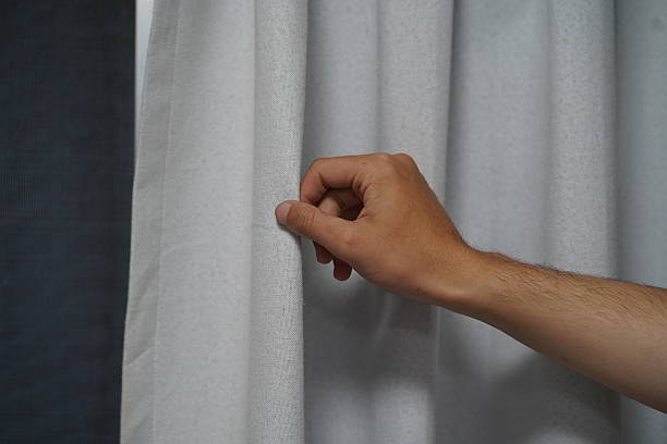 istock Hand Interacting with Soft White Curtain Fabric, Close-up View of Delicate Texture and Subtle Light Play, Home Decor Inspiration for Interior Design 2249374006