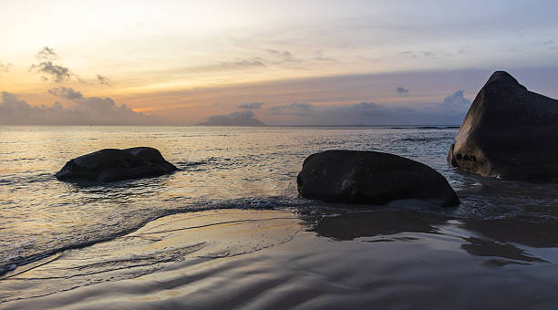 istock A tranquil coastal scene at dusk features gentle waves and golden reflections 2249374735