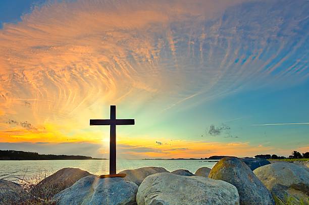 Dark Cross On The Rocks Sunset