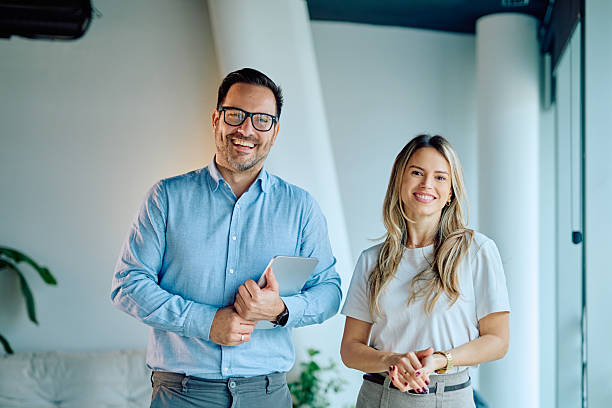 istock Smiling business people collaborating in modern office setting 2249378947
