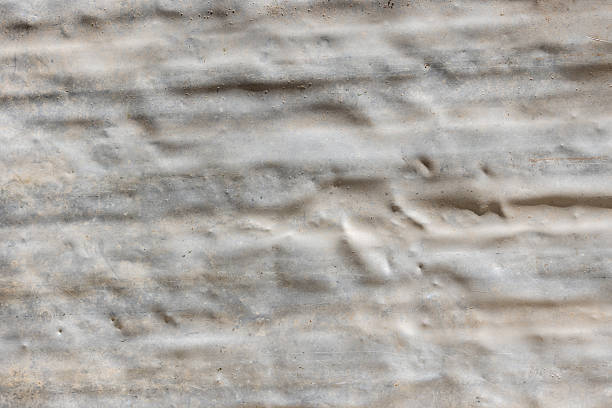 Wrinkled dirty aluminum sheet on ground outdoors during daytime