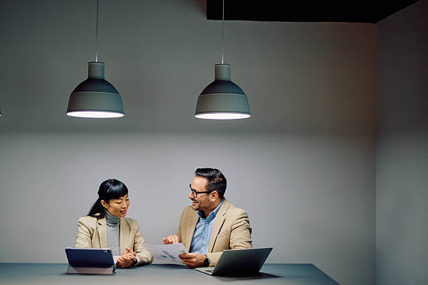 istock Colleagues collaborating on business reports in meeting room 2249380180