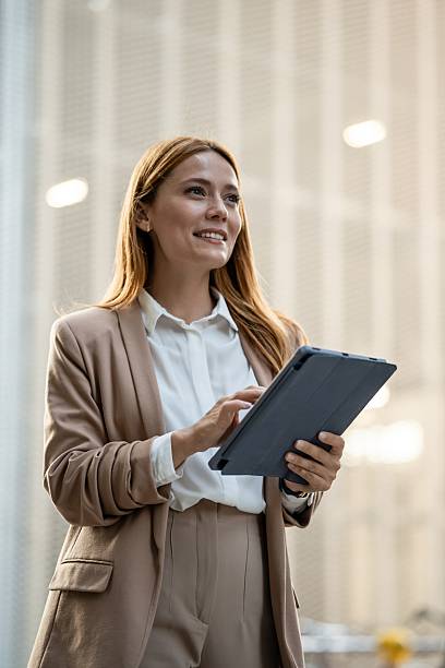 istock Businesswoman using digital tablet and looking up with a smile 2249381359