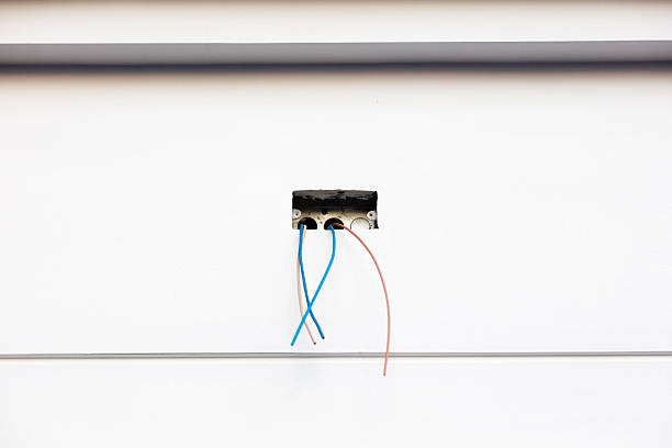 Electrical cables and phases at hole in surrounding wall of home under construction