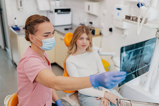 istock Dentist explains dental X-ray results to patient during routine check-up in a modern clinic setting 2249388026