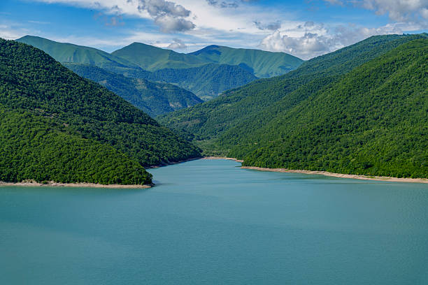 istock Serene blue mountain reservoir between lush green hills 2249394910