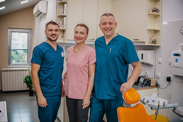 istock Team of dentists posing together in modern dental office during a working day 2249395570