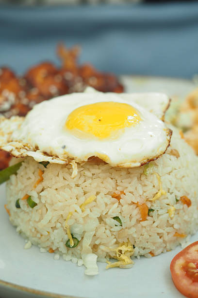 istock Fried rice topped with a sunny-side-up egg and side items 2249396878