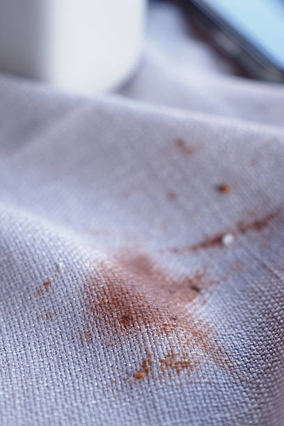 istock Coffee stain on white fabric in cozy cafe setting 2249397959