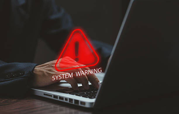 istock A laptop user facing a glowing red system warning symbol, representing cyber threats, system errors, malware alerts, and critical security issues in modern digital environments. 2249398872