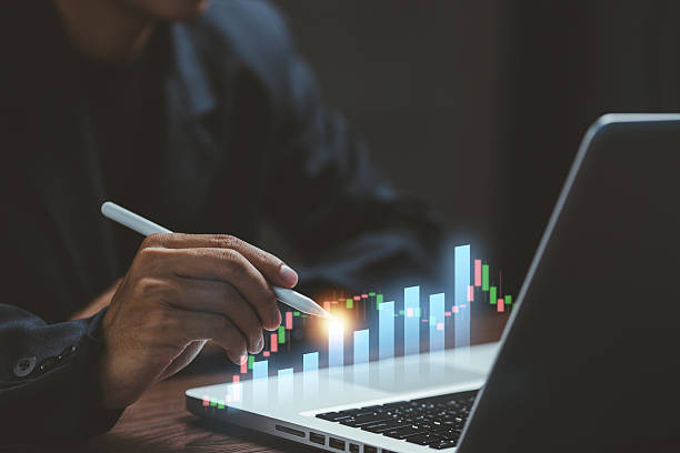 istock A businessman analyzing digital bar charts on a laptop, representing business analytics, financial growth, data insights, and performance monitoring in modern workplaces. 2249398878