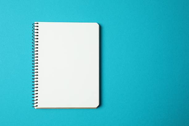 Top view of pencil and notebook on color background, top view