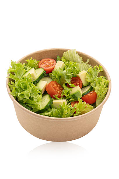 istock Green salad with vegetables on a white isolated background 2249400604