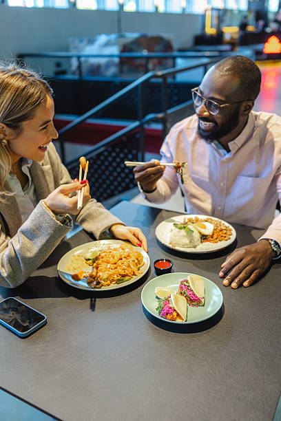 istock Two coworkers share a lively lunch break at a casual self-serve restaurant 2249400818