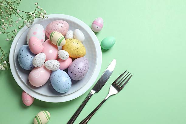 istock Happy Easter. Top photo with plate, cutlery, eggs on color background with empty space 2249401001
