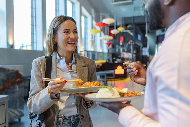 istock Friendly colleagues share a lunch break in a bright self-service restaurant 2249401003