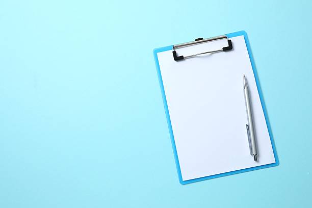 istock Clipboard with paper sheet on blue background, top view. Space for text 2249402313