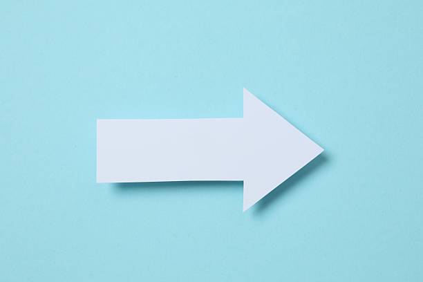 istock Paper arrow on color background, top view 2249402420