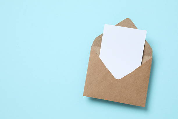 istock Paper envelope with white card on color background 2249402424