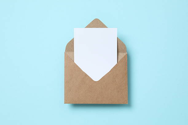istock Paper envelope with white card on color background 2249402427